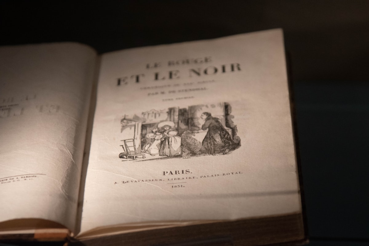 A book open to a page with a page that has a picture of people on it