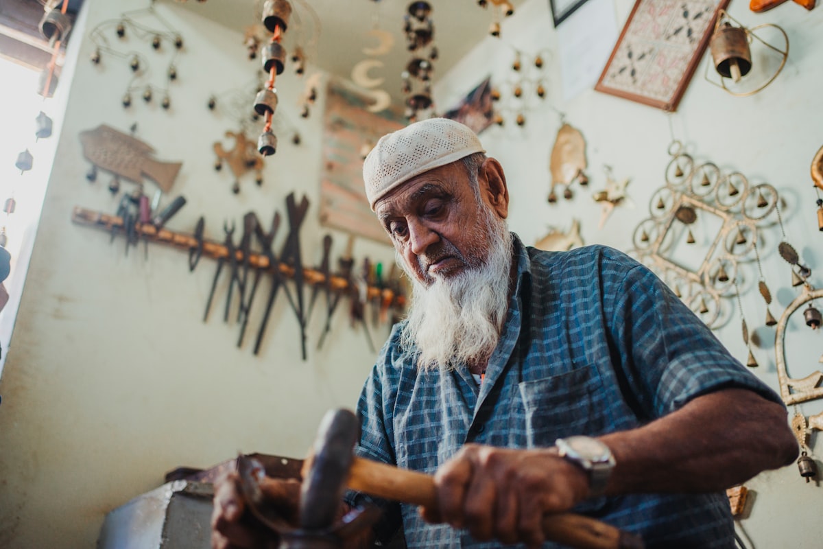 A man with a long white beard holding a hammer