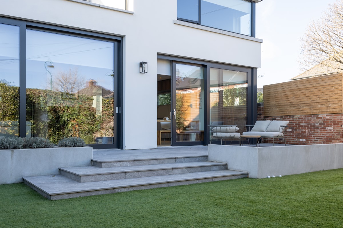A house with a lawn and steps leading to it