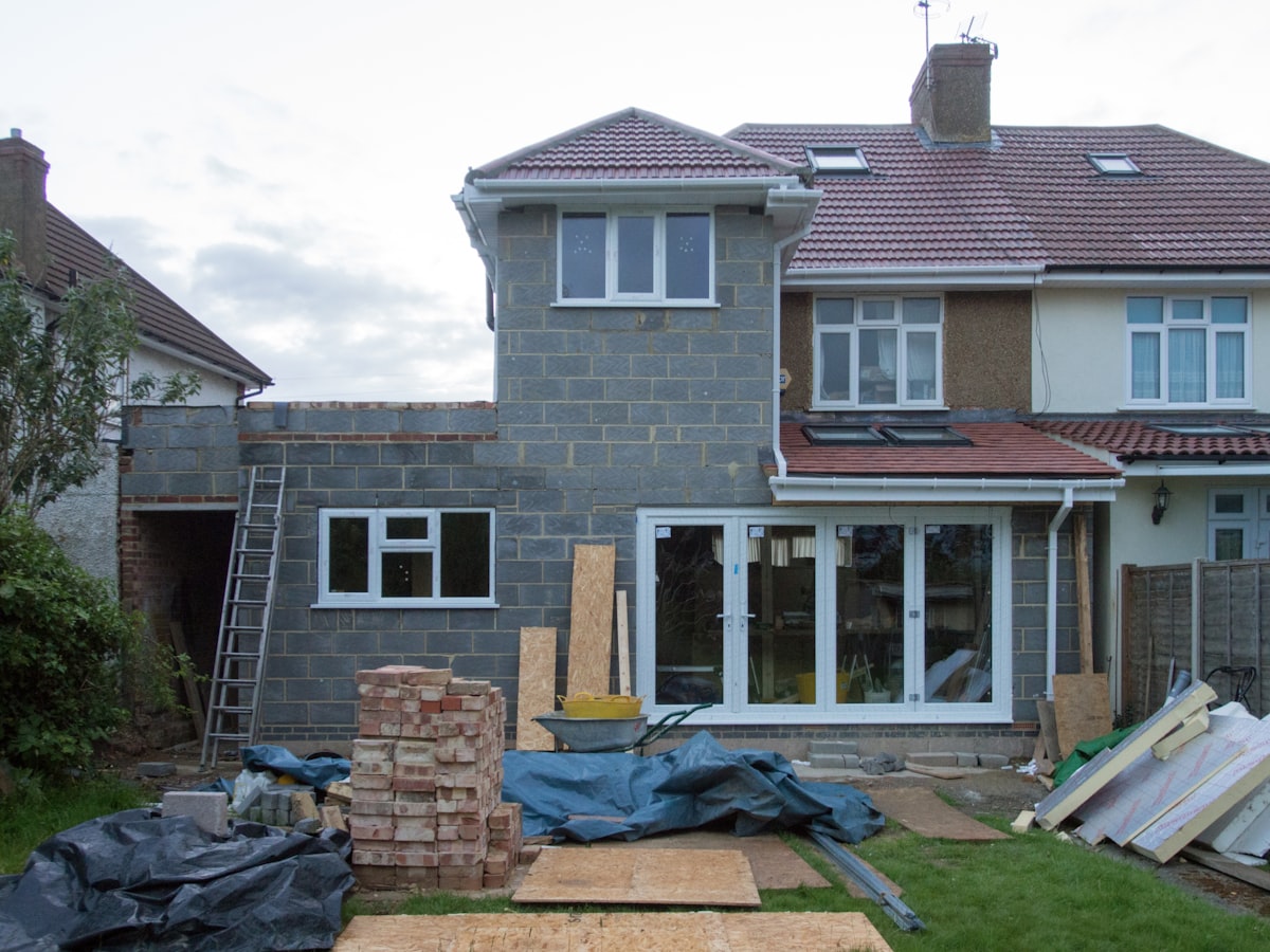 A house that is under construction with a ladder in front of it