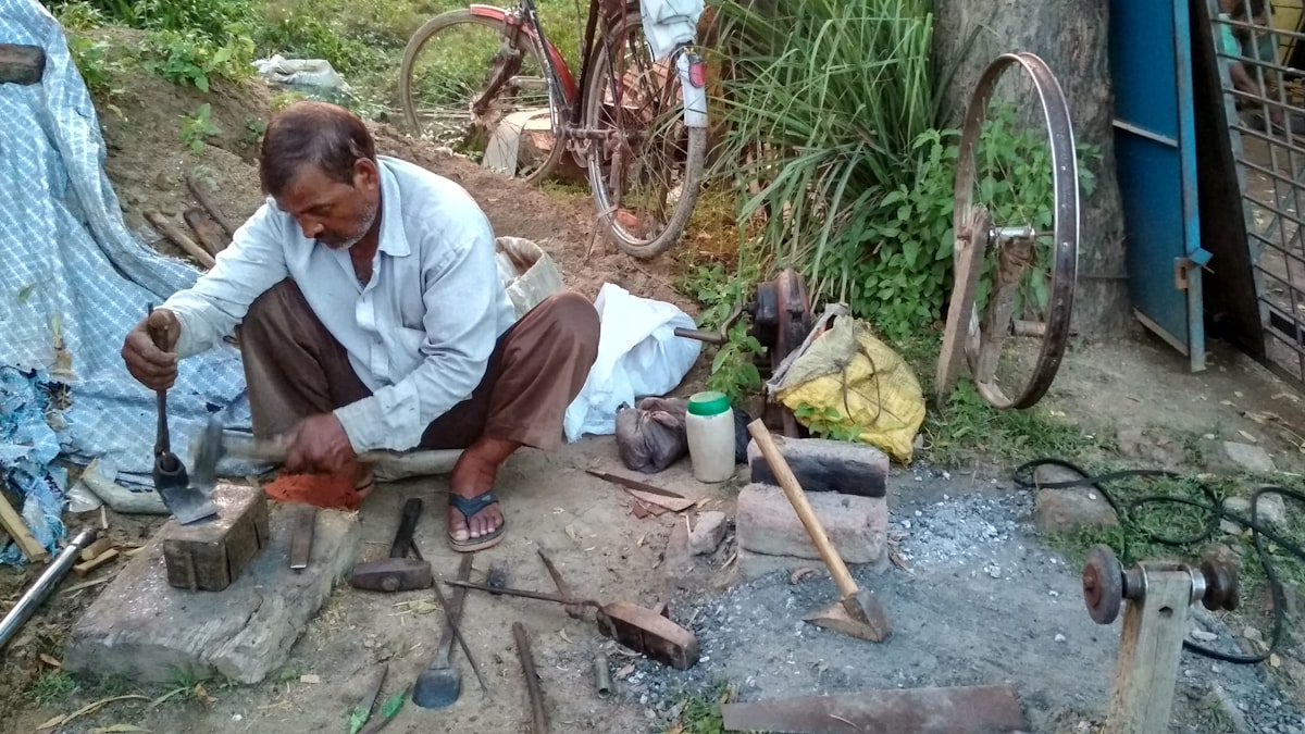 Man in white dress shirt sitting on brown wooden chair